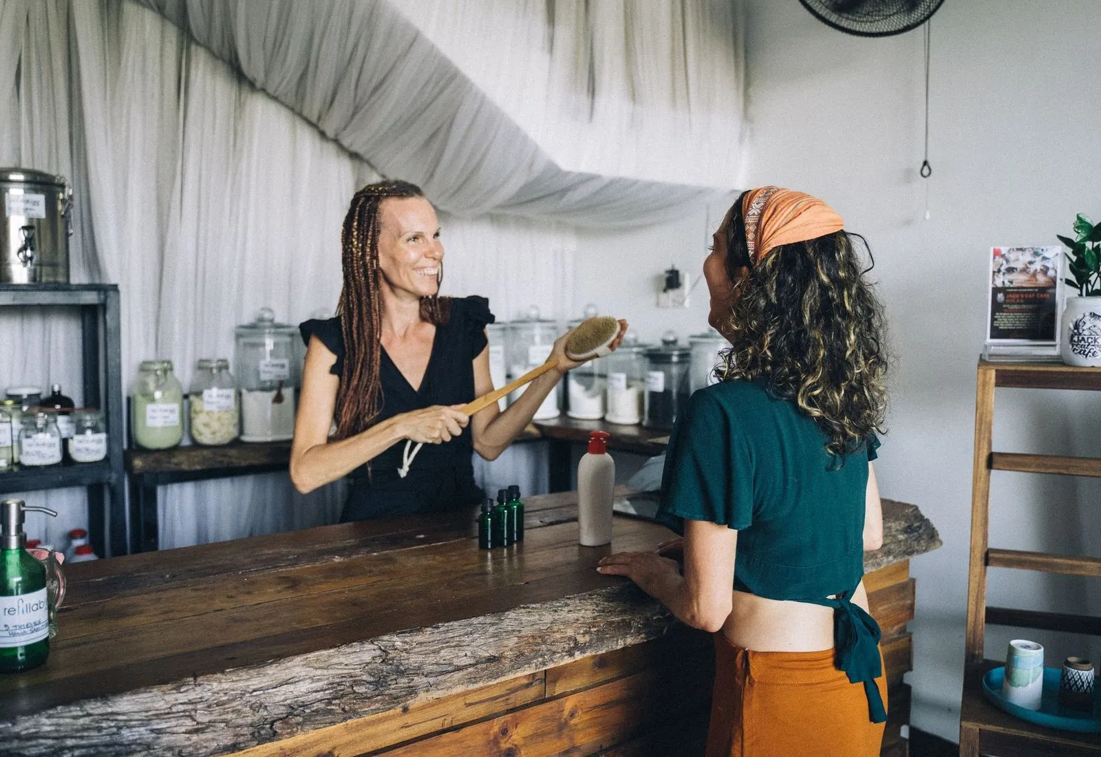 Shop owner chatting with a customer across the counter of her store